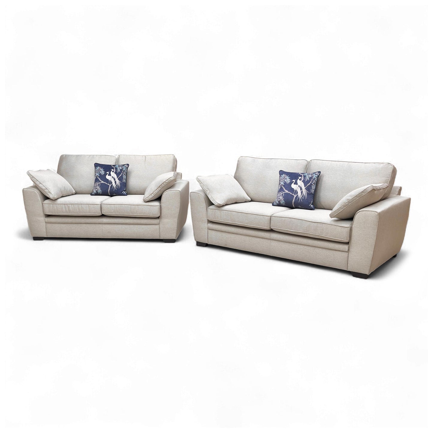 Angled shot of the sofa set, displaying the depth of the seating and the small, dark wooden legs.