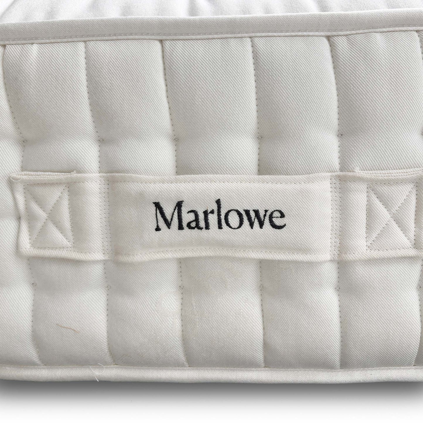 Close-up of the official Harrison Spinks / Feather & Black branding label and tag, confirming the high 12,000 spring count.