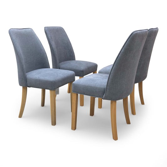 Angled view of the Hamilton dining chair showing the tapered wood legs and textured grey fabric upholstery.