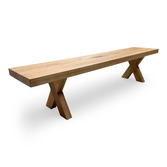 Full shot of the Bodahl ‘Njord’ 06 Dining Bench, showcasing the solid oak construction in an Old Bassano finish with wooden X-shaped legs.