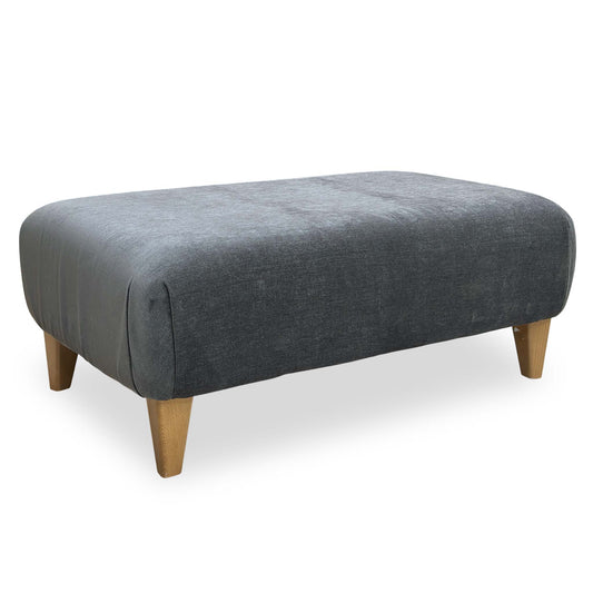 Front perspective of the Furniture Village ‘Soho’ Garda rectangular footstool in Carbon dark grey fabric.