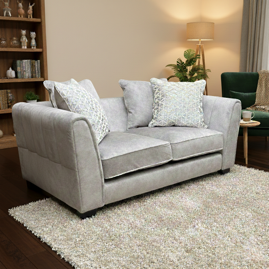 Living Room view of the cream dapple velvet 2-seater sofa, highlighting the textured fabric and curved arms.