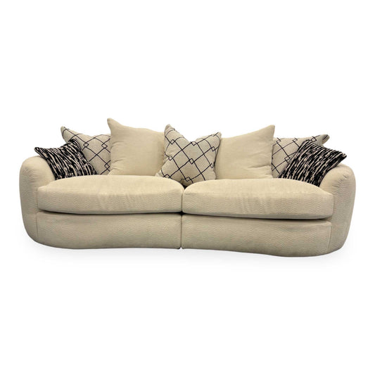 Front view of the Fabb ‘Bow’ 4-seater sofa in Ecru Ivory Boucle fabric featuring a curved backrest.