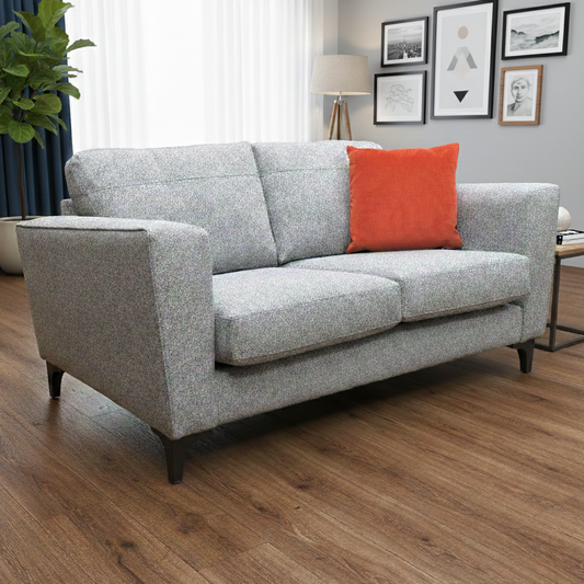 Living Room view of the ‘Lille’ 2-seater sofa, showcasing the structured cushions and silver grey fabric.