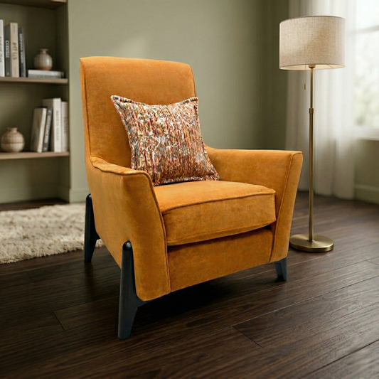 Living Room view of the ‘Collins’ orange armchair highlighting the modern sloped armrest design.