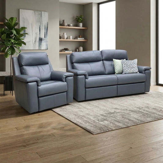 Living room view of the navy blue leather G Plan Thornbury sofa and chair set styled in a bright, modern living room, emphasizing its classic aesthetic and premium leather finish.