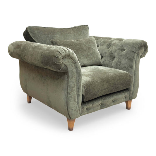 Full View The ‘Palace’ armchair in Derwent Moss fabric, featuring a classic back design, deep-seated comfort, and elegant dark wood legs.