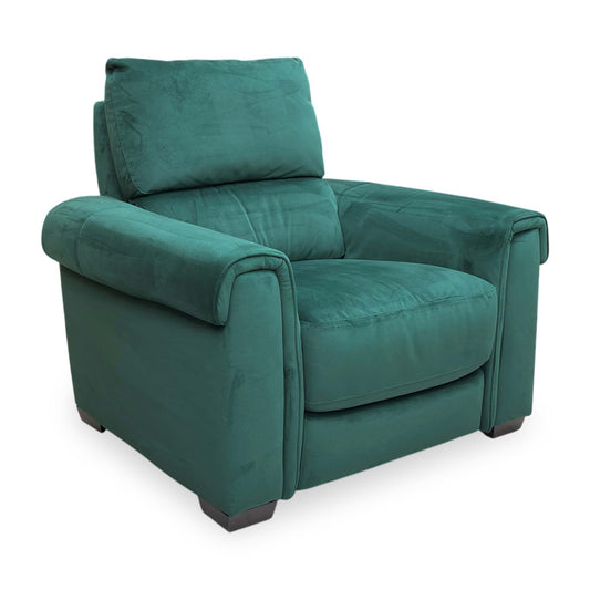 Full view for the ‘Nixon’ armchair in Emerald Green velvet, featuring a sleek mid-century modern design with a deep-buttoned back and slim black tapered legs.