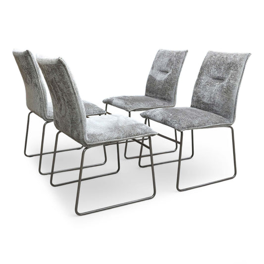 Full view of Set of four Connubia Maya dining chairs upholstered in taupe fabric with contemporary lava-finished metal ski-style legs.