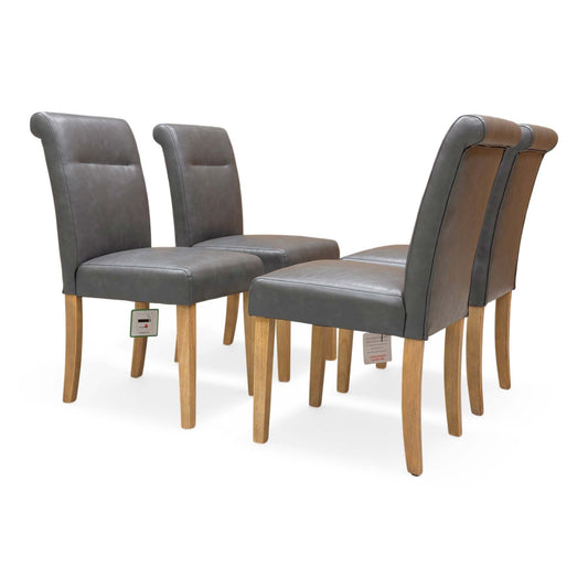 Full view of Set of four Lewis roll-back dining chairs in dark grey faux leather with elegant button-back detailing.