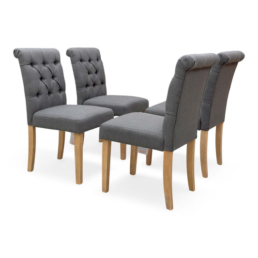 Full View ‘Lewis’ contemporary dining chairs, showing a matching set of 4 individual chairs beautifully upholstered in a luxurious, durable Anthracite Grey fabric with an elegant button-back design.