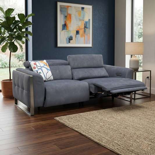 Living room view for the Gisella 3-seater sofa, highlighting the power reclining mechanism, power adjustable headrests, and premium charcoal velvet.