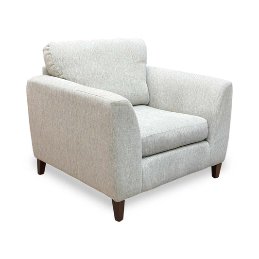 Pippa armchair in grey woven fabric with dark wood block legs, angled view