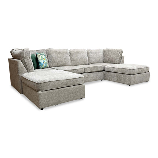 Full view of a wide frontal view of the Emilia large U-shaped corner sofa upholstered in Stone woven fabric, featuring a symmetrical design with dual chaise ends.