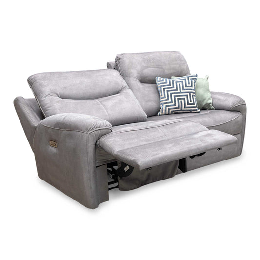 Full view of the charcoal velvet sofa, showcasing the high backs, deep seats, and distinctive arm cushion design exclusive to Furniture Village.