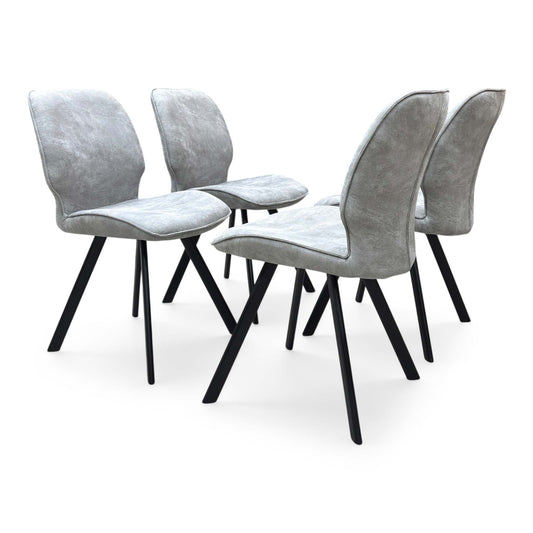Side profile of the Montreal dining chair, showcasing its ergonomic frame contour, supporting depth, and tailored fabric stitching.