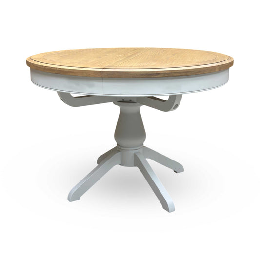 Full view of the Furnitureland ‘Hamilton’ round fixed dining table, crafted from solid American oak with a natural grain finish and a classic circular tabletop.