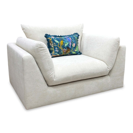 Full View DFS ‘Kalista’ snuggle cuddler chair, featuring an oversized curved frame fully upholstered in premium cream Palmero plain velvet fabric.