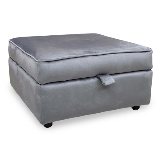 Full view of the ‘Felix’ round storage footstool in Steel Grey velvet, featuring a compact cylindrical design with a matching upholstered lid and black metal legs.