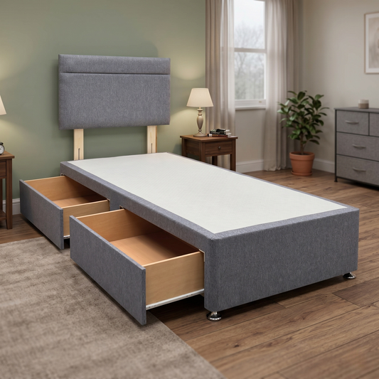 Living room view for the Capella single divan bed, highlighting the textured Orkney charcoal fabric, the integrated 2-drawer storage setup, and the sturdy timber base construction.