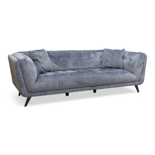 Full view of the ‘Rene’ 3-Seater Sofa in Heritage Granite Grey velvet, showcasing its luxurious contemporary silhouette, deeply padded bench seating, and elegant matte black legs.