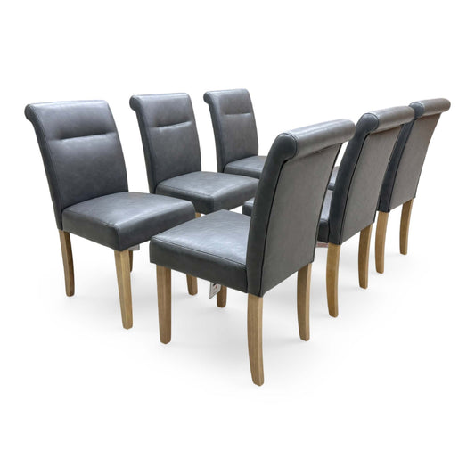 Full View Set of 6 Furniture Village ‘Lewis’ contemporary roll-back dining chairs, beautifully upholstered in dark grey faux leather with solid wood legs.