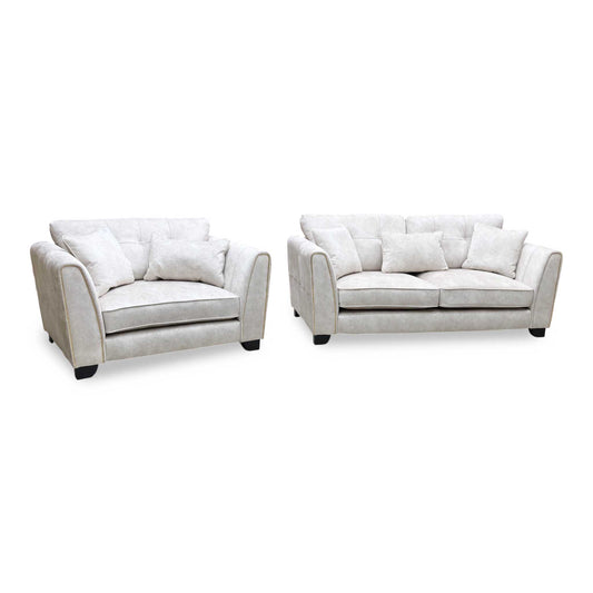 Full View ‘Mariah’ contemporary living room furniture set, featuring a 3-seater classic back sofa and matching snuggler chair, beautifully upholstered in luxurious Dapple Ivory fabric with elegant brushed brass structural trim inserts.