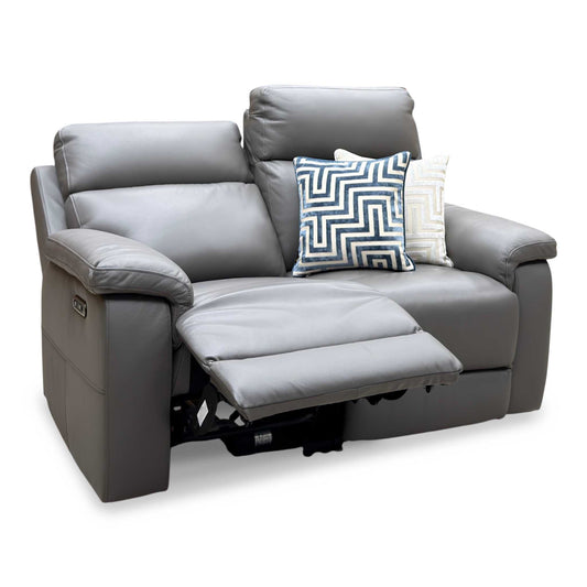 Raven elephant grey leather 2 seater power recliner sofa, angled view with the left seat reclined