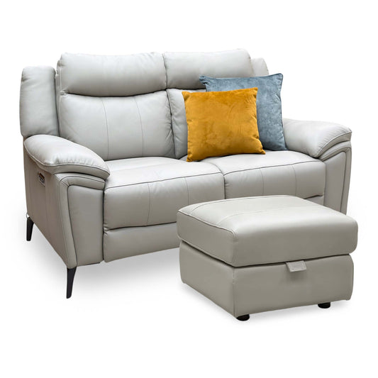 Panache lead grey leather 2 seater power recliner sofa with storage footstool, angled view with yellow and blue cushions