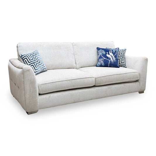 Boujee dove grey fabric 4 seater classic back sofa, angled view with blue patterned scatter cushions