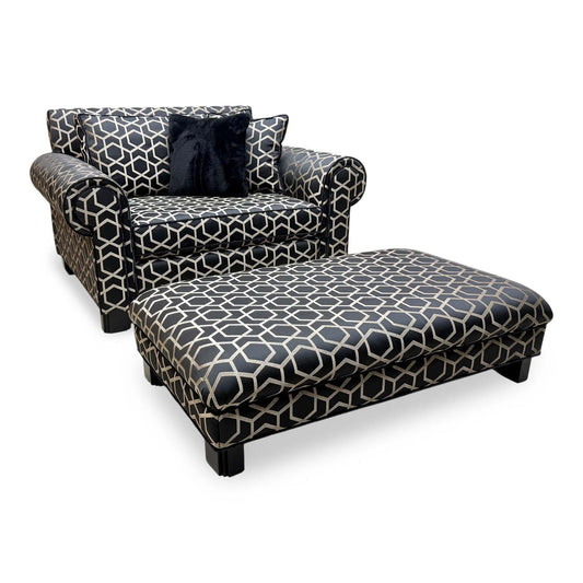 Duresta Ambassador black and gold patterned reading chair and footstool, angled view with a black faux fur cushion