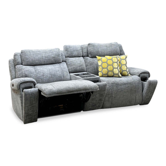 Hollywood dove grey fabric 3 seater power recliner media sofa, angled view with left seat reclined and yellow cushions