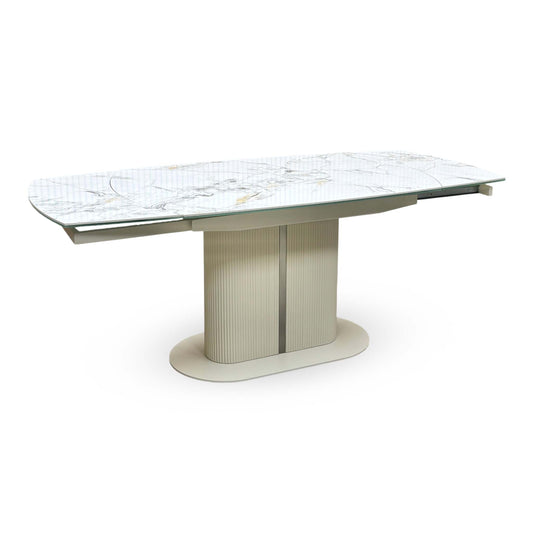 Avorio white marble-effect ceramic top swivel extending dining table fully extended, angled view on a cream pedestal