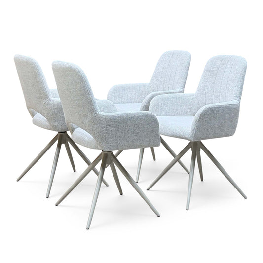 Pebble light grey fabric set of 4 swivel dining chairs, angled to show the backs of the front pair