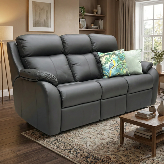 Living room view of the Kingsbury black leather sofa, highlighting the shapely side profile and thick, padded armrests.