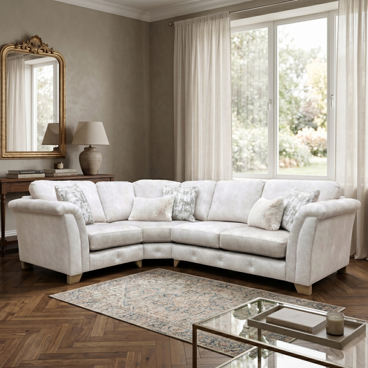 Living room view for the Aura classic back corner sofa, highlighting the luxurious cream velvet upholstery, rolled arms, and deep comfort silhouette.