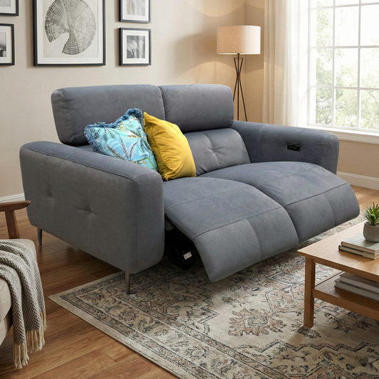 Lifestyle photograph of the 'Ezra' 2-seater sofa in a home setting, highlighting the luxurious velvet texture and sophisticated grey color palette.