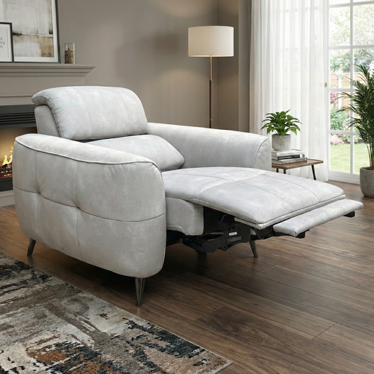 Living Room view of the ‘Leonardo’ armchair highlighting the plush grey velvet upholstery and contemporary silhouette.