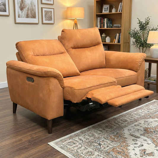 Living Room view of the pumpkin orange velvet 2-seater sofa, highlighting the luxurious fabric and contemporary design.