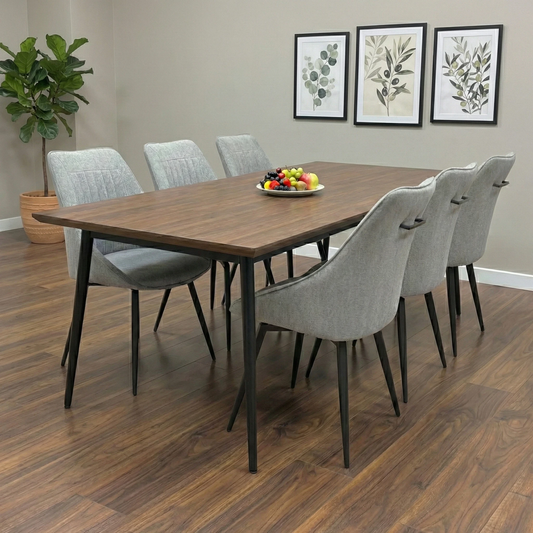Dining Room view of a silver fabric swivel chair highlighting the elegant curved silhouette.