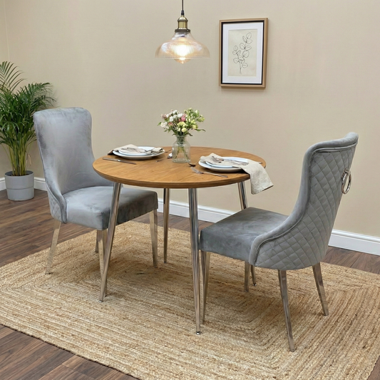 Living Room view of the grey velvet dining chair, highlighting its elegant curved silhouette.