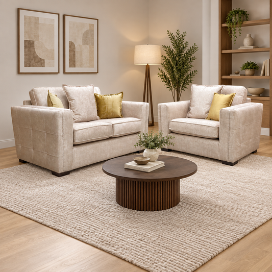 Chelsea beige velvet 2 seater sofa and snuggler chair in a living room with a round dark wood coffee table