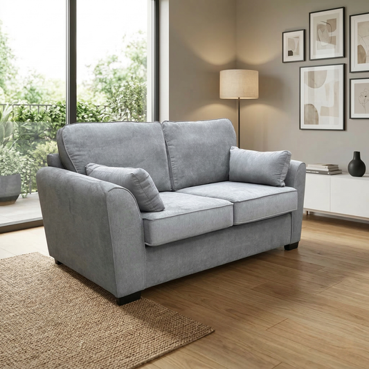Living room view roma 2 seater sofa bed in pewter grey linen fabric styled in a modern living room setting with decorative accessories.