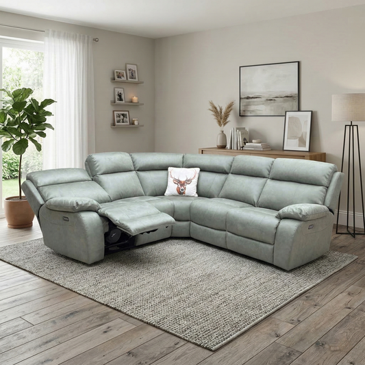 Living room view for the Moreno corner sofa, highlighting the smooth power reclining action, soft-touch suede fabric, high-density foam seating, and USB charging ports.