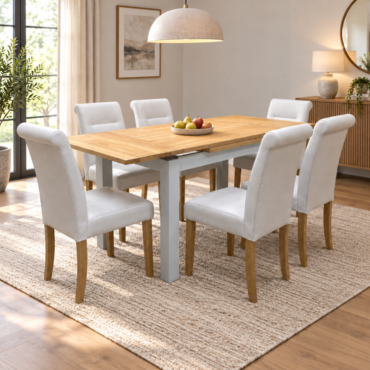 Lewis solid oak 120cm dining table set with six light grey chairs in a dining room with a jute rug and fruit bowl
