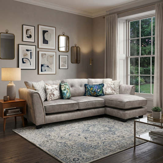 Living room view for the Mariah chaise sofa, highlighting the neutral Dapple Cream upholstery, the elegant brass inlay accents, and the spacious lounging chaise.
