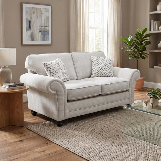 Styled upscale contemporary living room lifestyle layout featuring the Clara beige fabric 2-seater sofa arranged as a luxurious, sophisticated family lounge centerpiece.