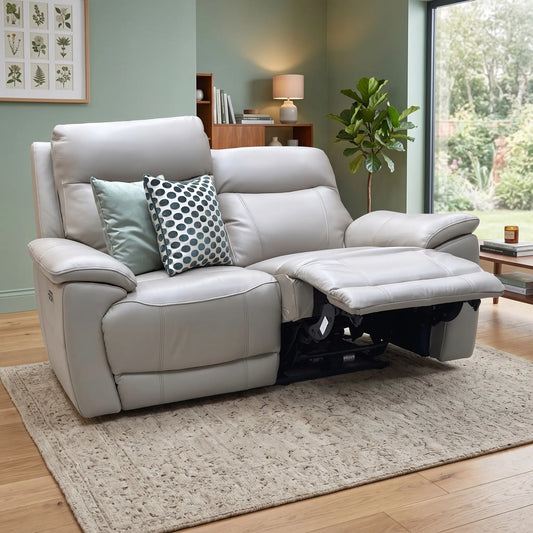 Styled upscale contemporary living room lifestyle layout featuring the Sloane Oyster leather 2-seater power recliner sofa arranged as a sophisticated, minimalist home comfort centerpiece.