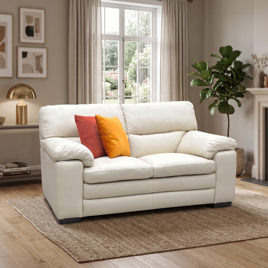 Styled upscale contemporary living room lifestyle layout featuring the Cozee bisque cream premium leather 2-seater sofa arranged as a luxurious, cozy seating option.