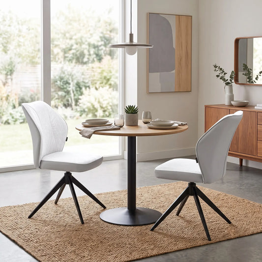 Styled upscale contemporary dining room lifestyle layout featuring the set of 2 Julio stone grey fabric chairs beautifully arranged at a modern glass or ceramic-top dining table.